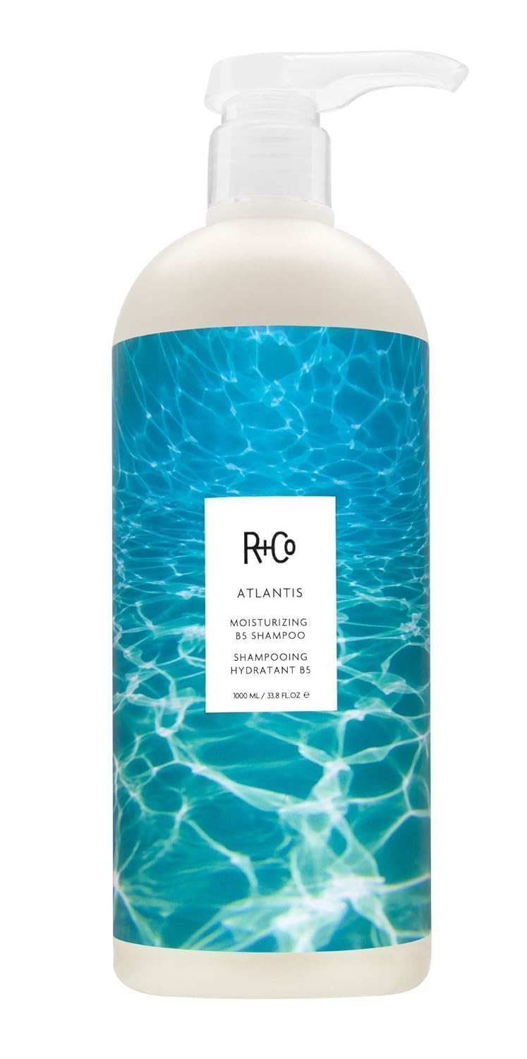 R+Co Atlantis moisturizing shampoo bottle front with smooth, hydrated hair implications.