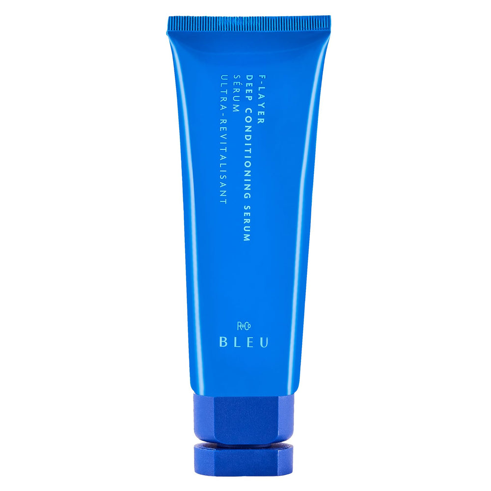 R+Co BLEU F-Layer bottle close-up showing weightless hydration.