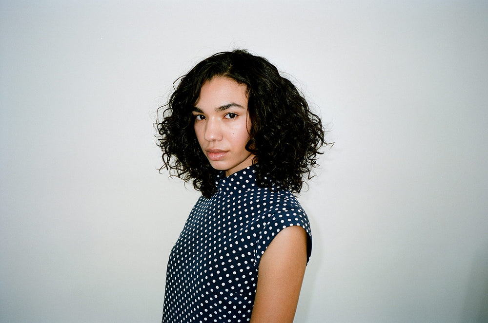 R+Co Cassette Curl Defining Masque applying to curls for revived softness