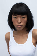 R+Co Dallas Biotin Thickening Conditioner model hero shot conveys volume and shine.
