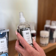 R+Co Dallas spray dispense closeup shows even application for fuller hair.