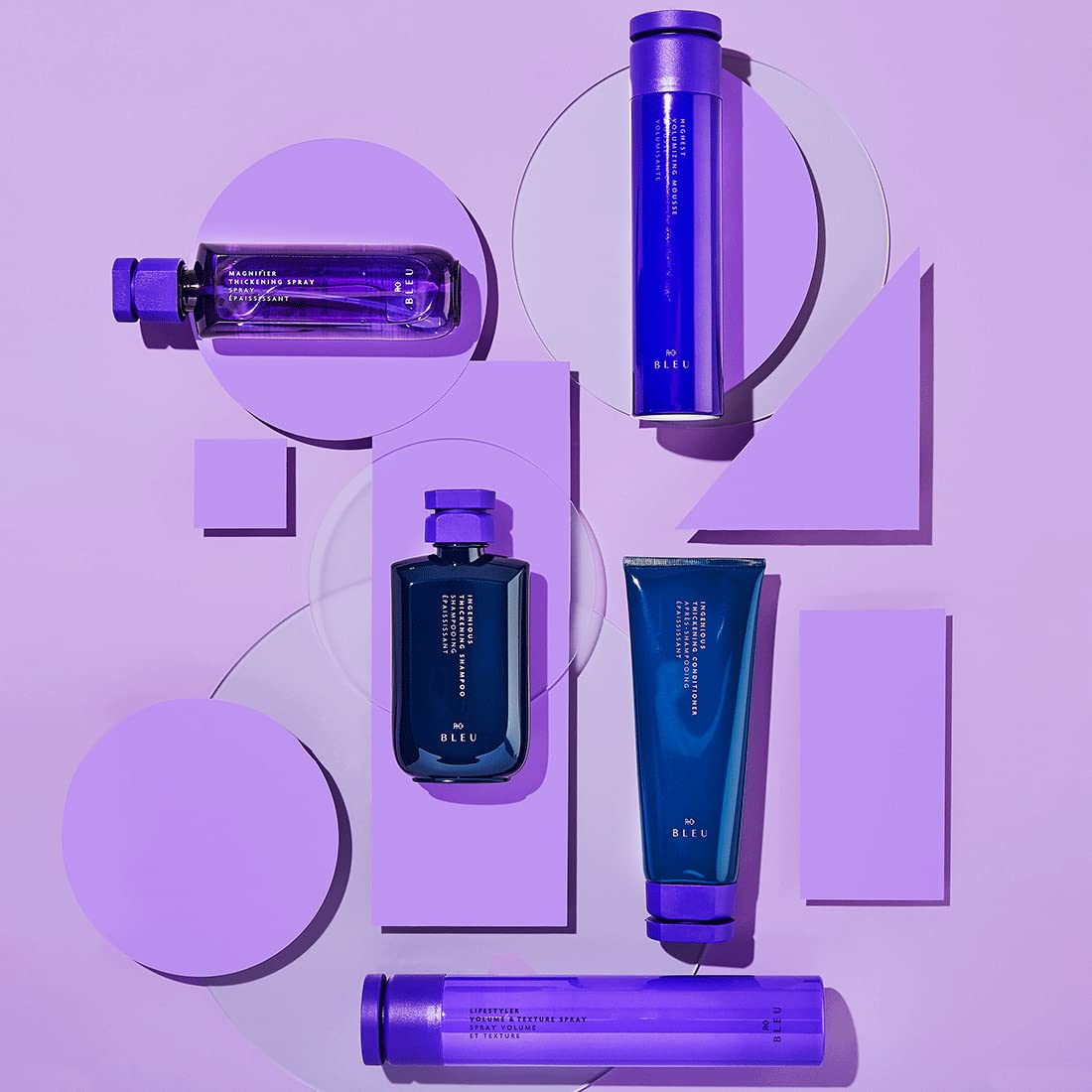 R+Co Magnifier Thickening Spray mist applied to hair during styling for added volume.