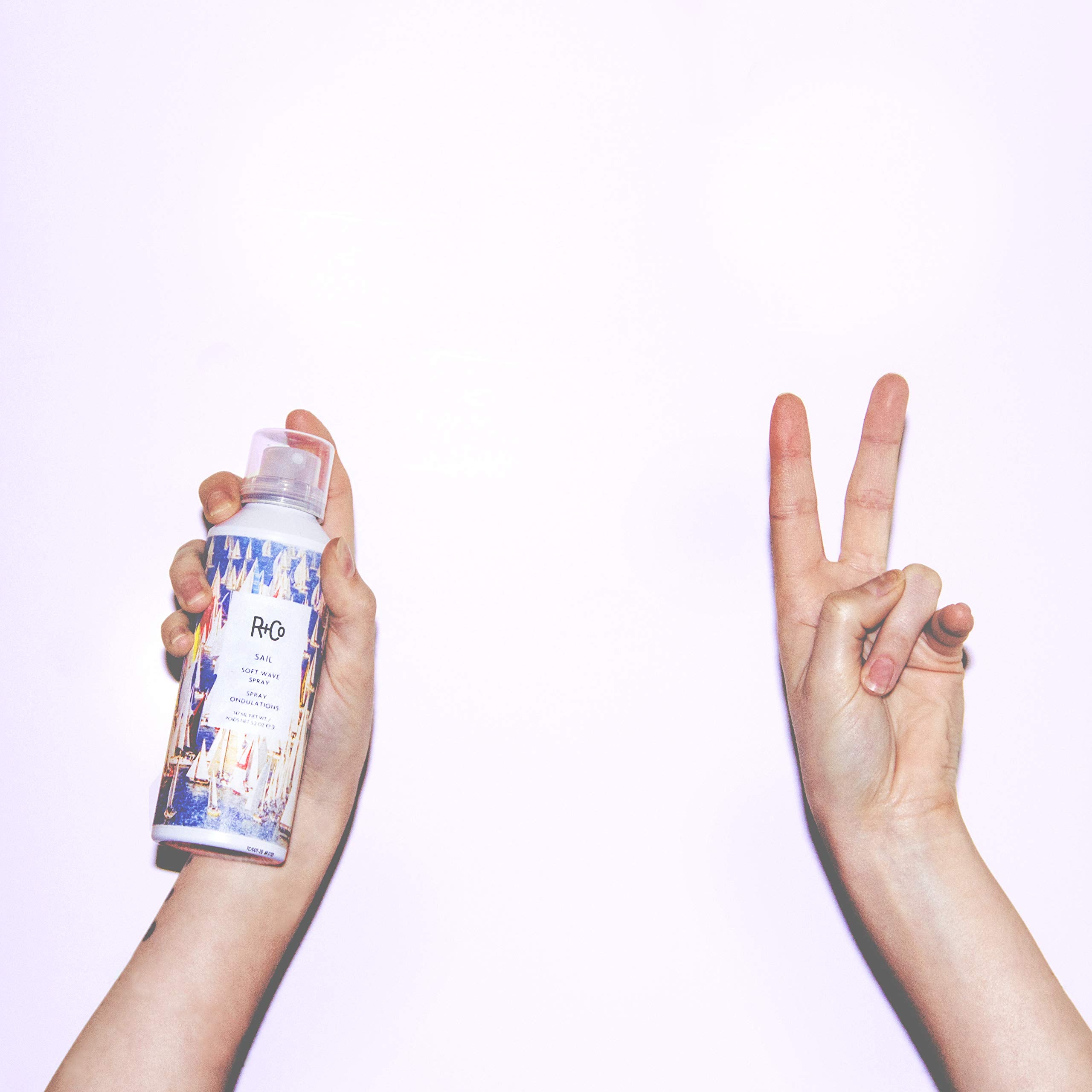 Application shot of R+Co Sail Soft Wave Spray distributing texture evenly through hair