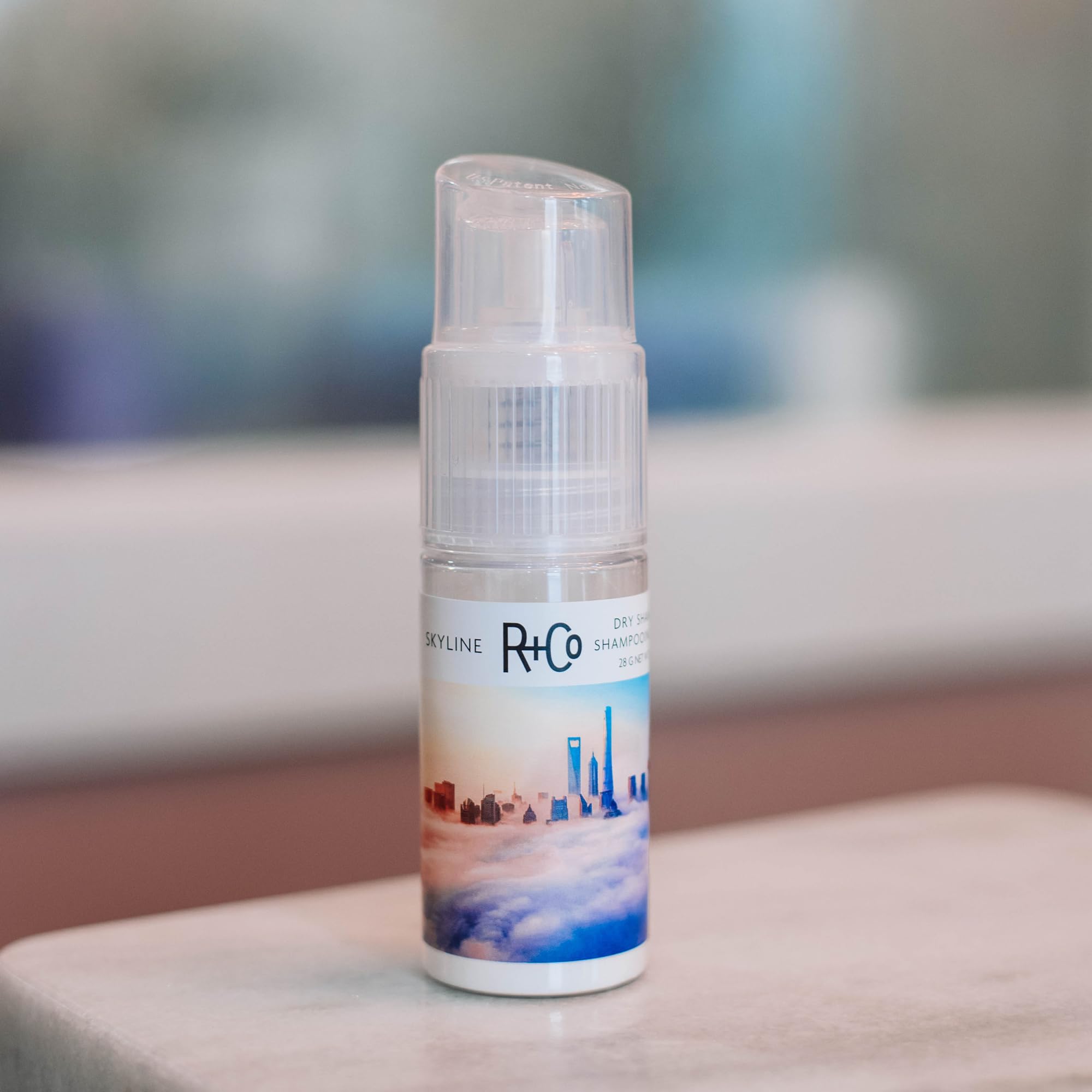 R+Co Skyline dry shampoo powder offers refined powder spray for precise targeting
