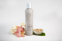 Redavid conditioner being poured, showing smooth glide for detangling.