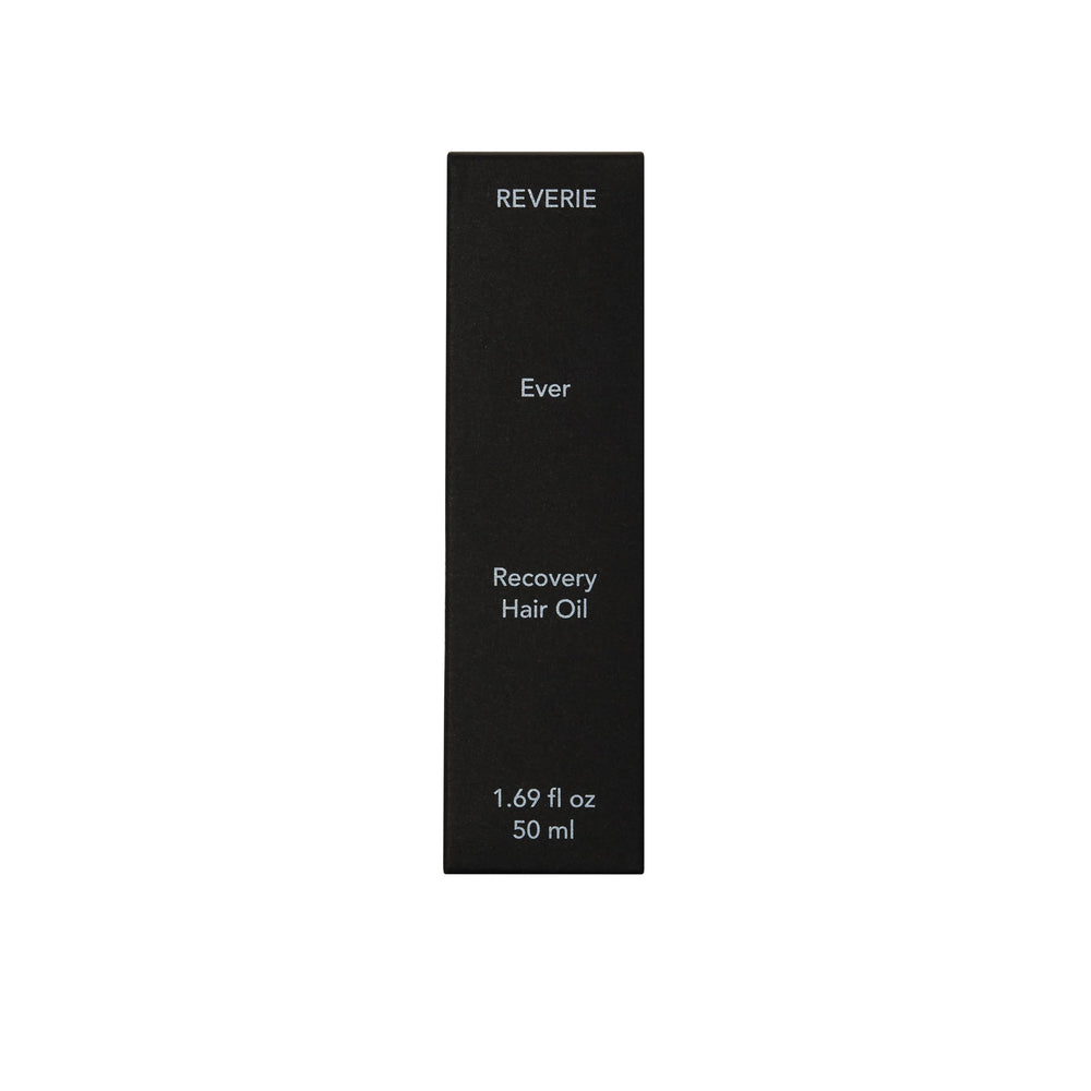 REVERIE Ever Recovery Oil on hair during application highlights smooth strands.
