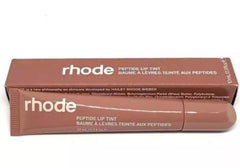 Rhode Peptide Lip Tint tube close-up shows a sheer, hydrating gloss.
