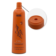 Applying Richée Argan and Ojon oil to lengths for shine and softness.
