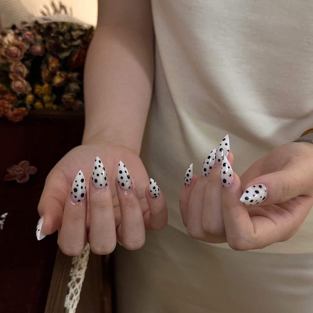 RIICFDD polka-dot design nails on hand.