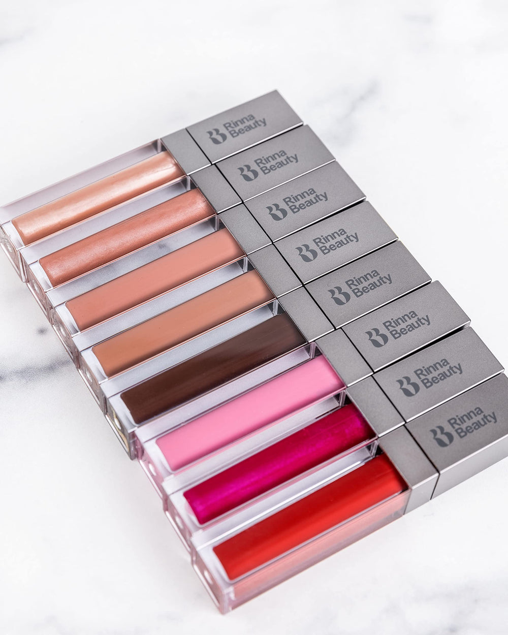 Rinna Beauty Guilty Pleasure swatch on diverse skin tones.