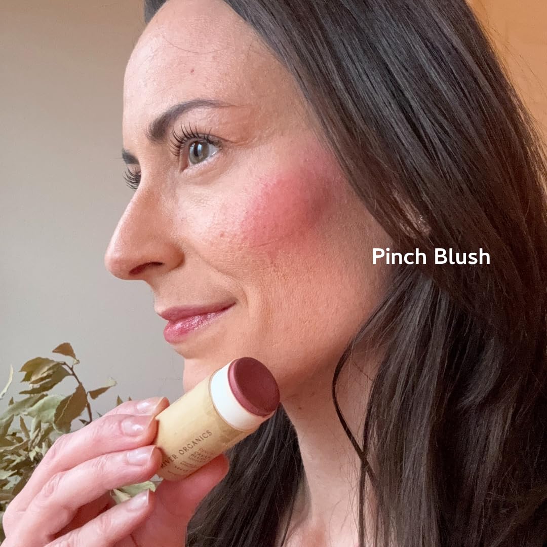River Organics blush stick on lips for a subtle, hydrated color.