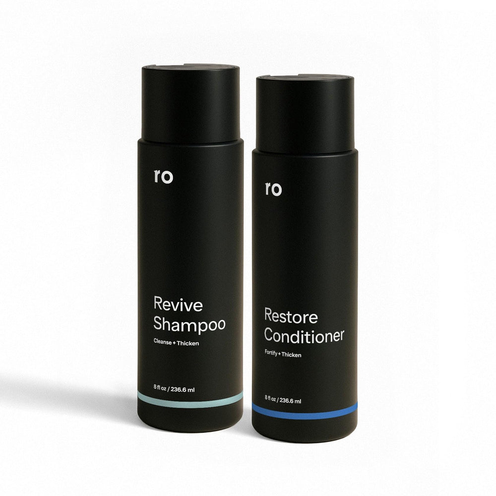 Ro Men's Revive Shampoo bottle on bathroom counter for thicker-looking hair.