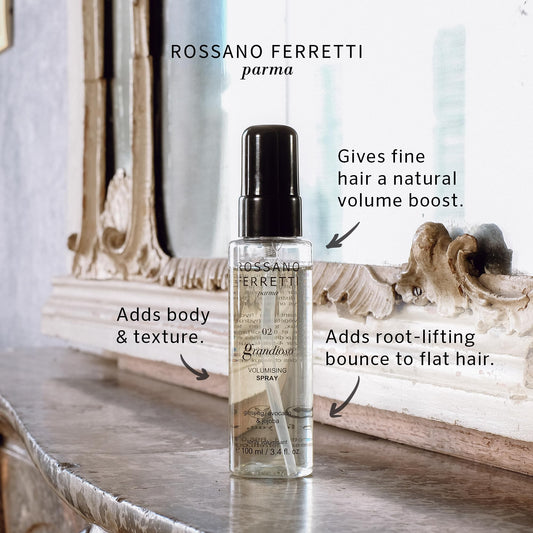 Grandioso Volumizing Spray mist applied to hair for lift and volume.