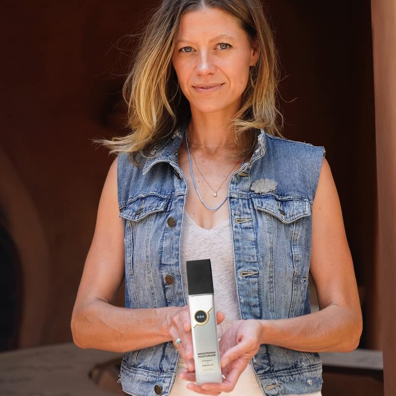 User applying moisturizer to face and neck in morning routine.