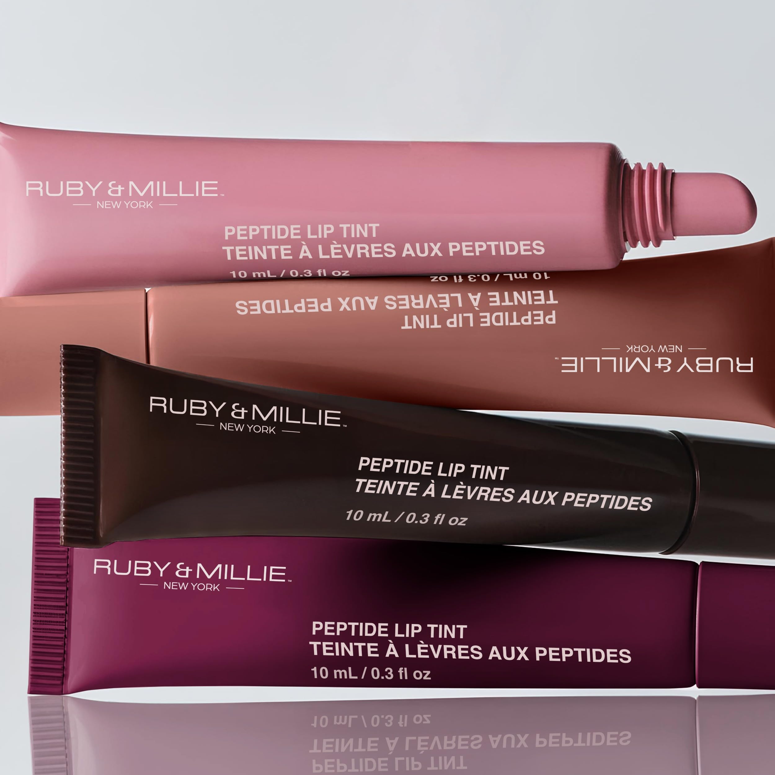 Ruby & Millie lip gloss on lips shows bright shine and fullness.