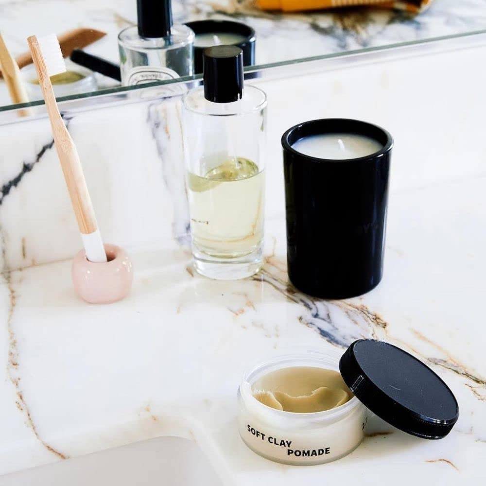 Rudy's Soft Clay Pomade hands warming to activate pliable texture.