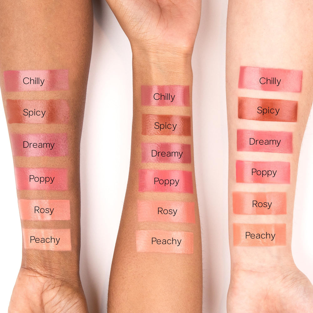 Saie Dew Liquid Blush being blended with fingers for a natural flush.