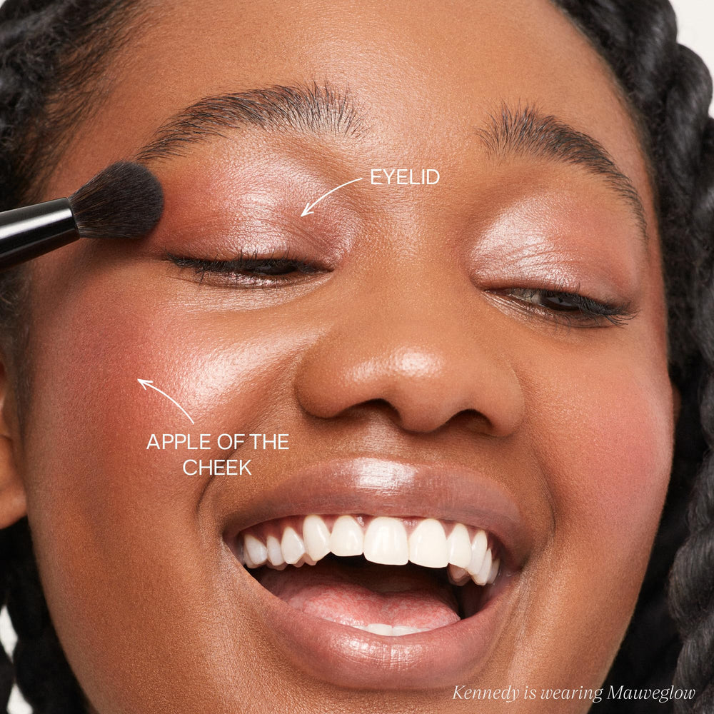 The Double Brush large end applying lift on cheekbones for sculpting.