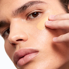 Application brush blending Saie Glowy Super Skin Tint for smooth coverage