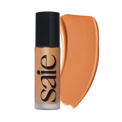Saie Glowy Super Skin Tint bottle cap close-up highlighting a luminous finish.