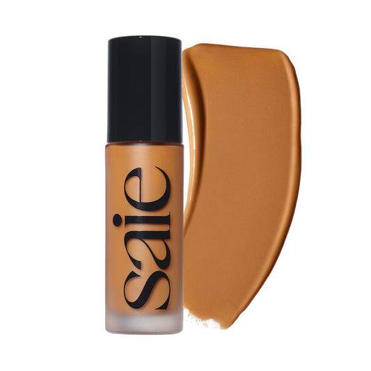 Saie Glowy Super Skin Tint bottle close-up showing luxe packaging and dewy finish.