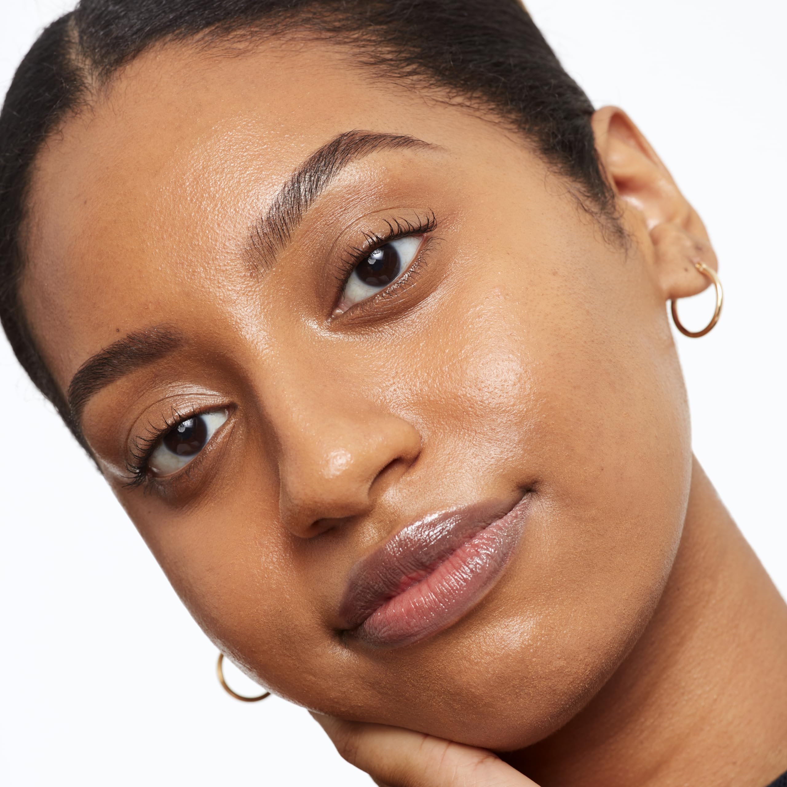 Saie Glowy Super Skin Tint pressed into skin for weightless, even coverage.