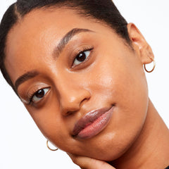 Saie Glowy Super Skin Tint pressed into skin for weightless, even coverage.