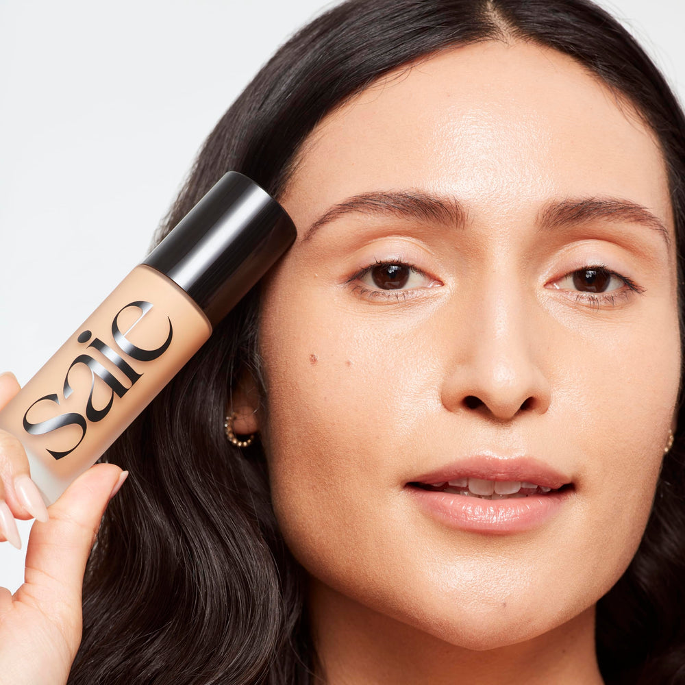 Saie Glowy Super Skin Tint pump onto fingertips for precise application