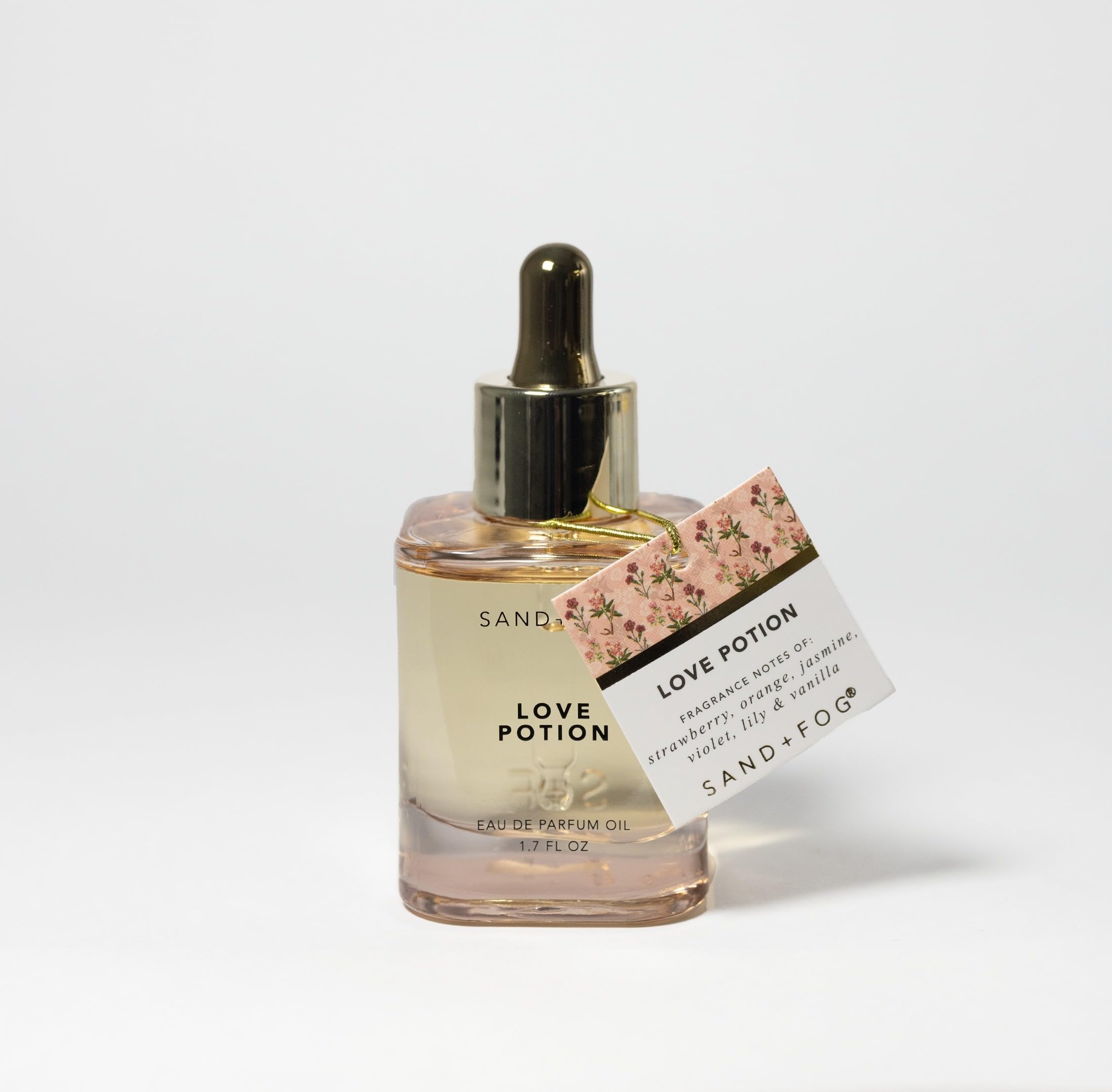 Sand + Fog Love Potion dropper application shown for easy, lasting fragrance