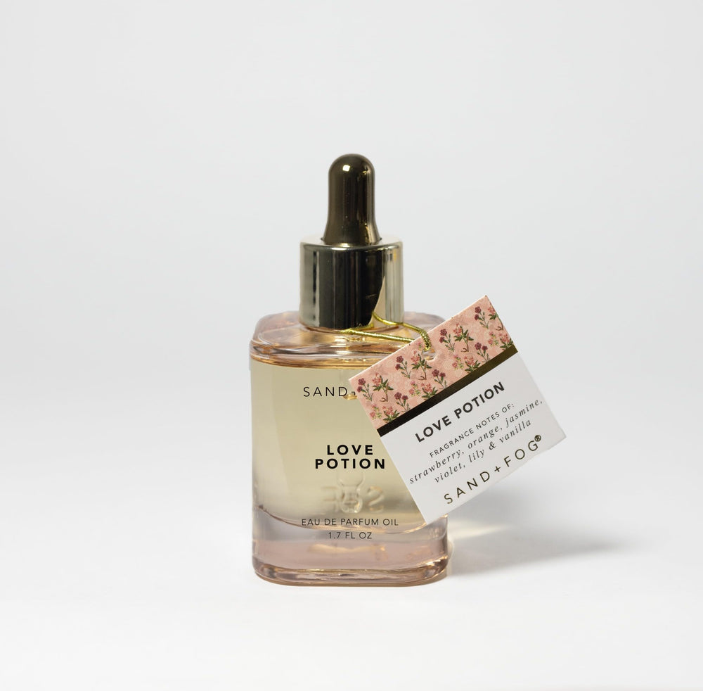 Sand + Fog Love Potion dropper application shown for easy, lasting fragrance