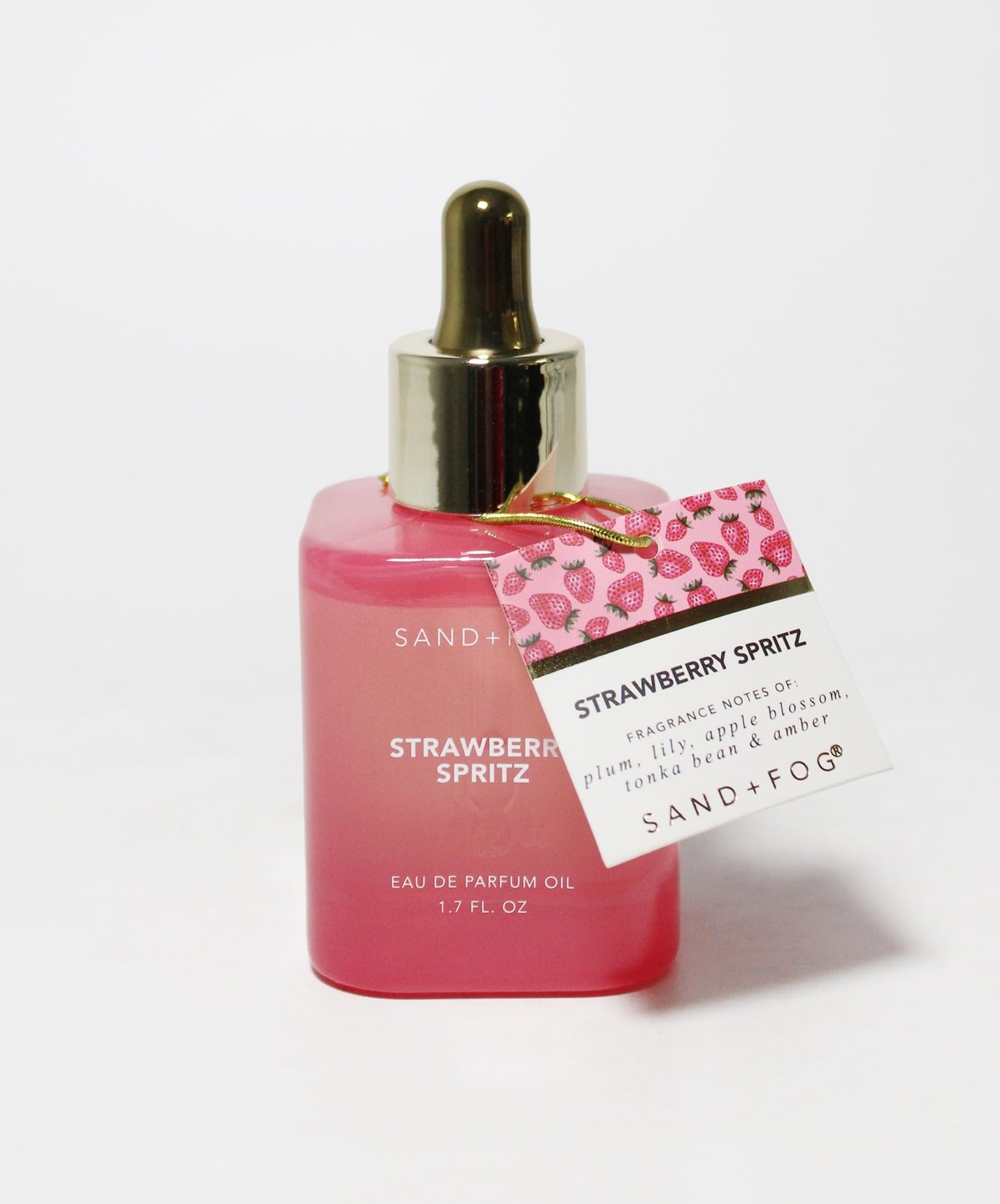 Sand + Fog Strawberry Spritz close-up label highlights oil-based formula for lasting wear