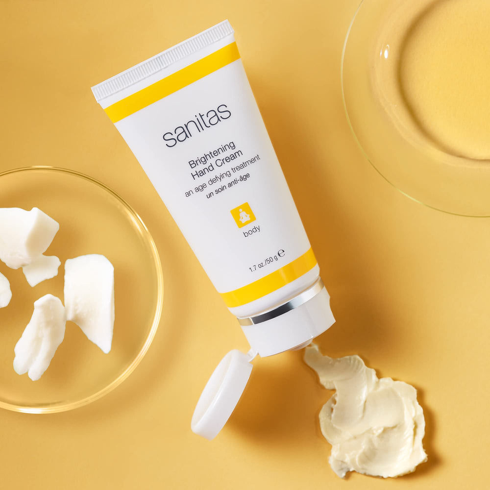 Sanitas Brightening Hand Cream texture close-up shows creamy mango butter for hydration.