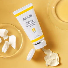 Sanitas Brightening Hand Cream texture close-up shows creamy mango butter for hydration.