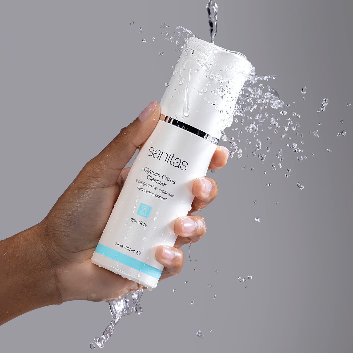Hand applying Sanitas Glycolic Citrus Cleanser to prep skin for serums and moisturizers.
