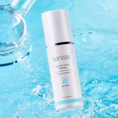 Close-up of the gel texture of Sanitas Glycolic Citrus Cleanser exfoliating to reveal a clearer complexion.