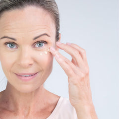 Saranghae triple mushroom eye cream tube close-up emphasizing puffiness care.