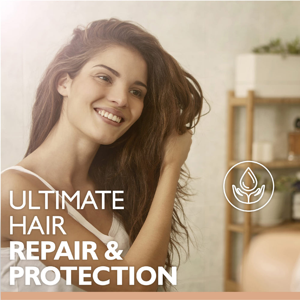 Saryna Key Repair Oil on towel-dried hair smoothing frizz and increasing manageability