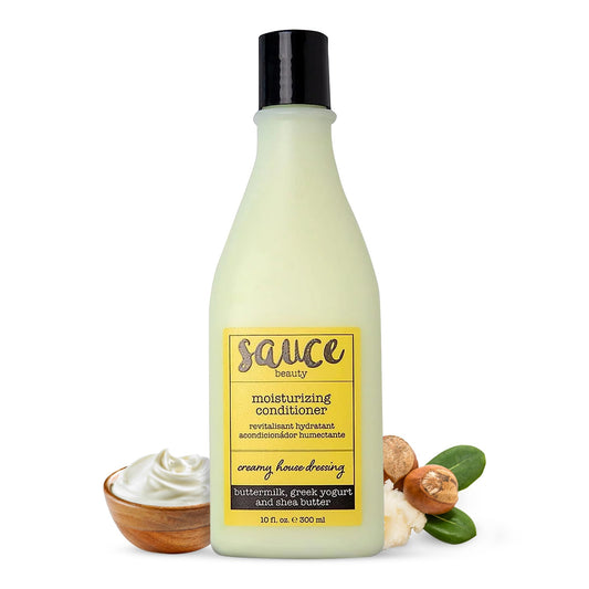 Sauce Beauty Creamy House Dressing Conditioner bottle shows a hydrating, frizz-control formula for curls.