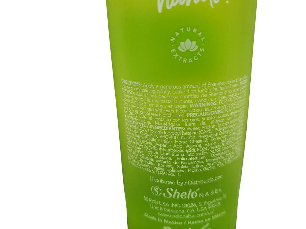 Sheló NABEL Bergamot Shampoo close-up on damaged hair shows nourishing care.