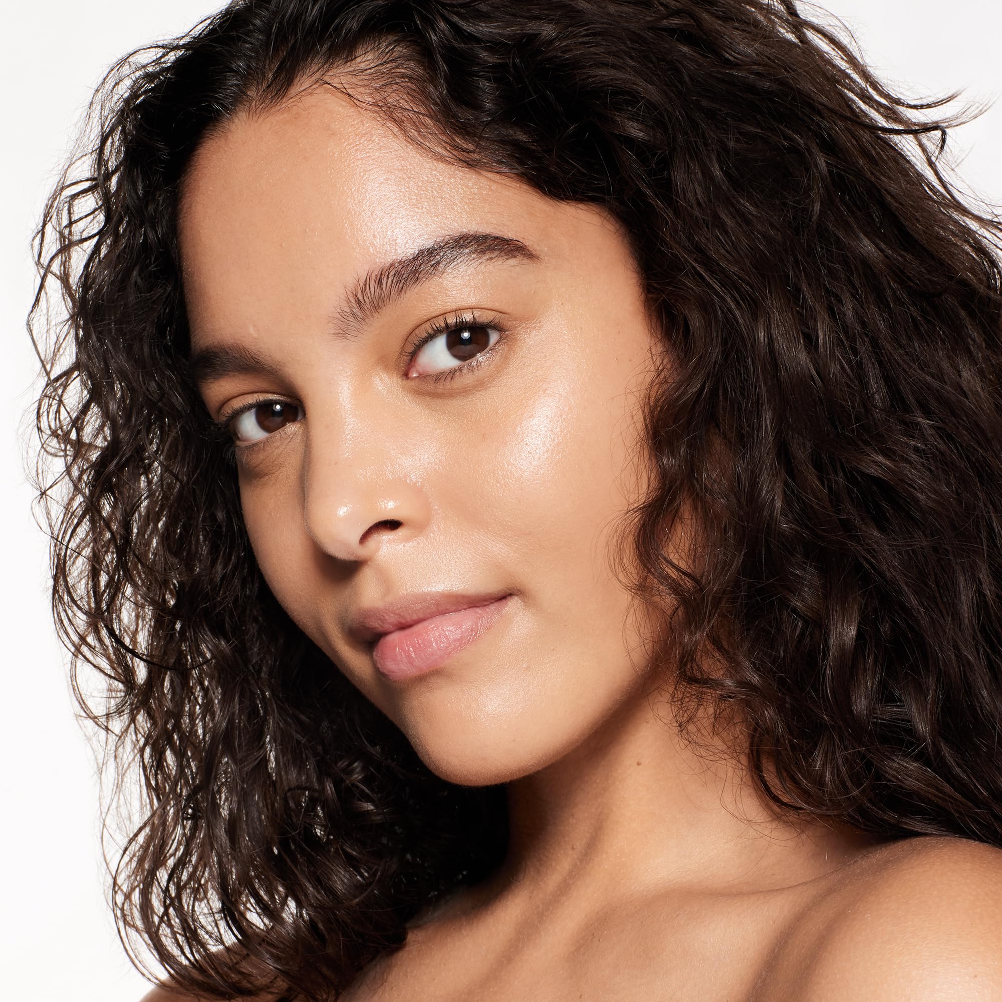 Swatches on arm showing buildable coverage and skin-tone balance with Shiseido RevitalEssence