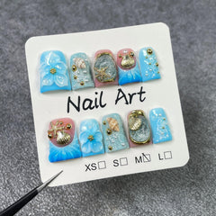 Short Duck handmade press-on nails with golden starfish and shell accents for glam occasions.