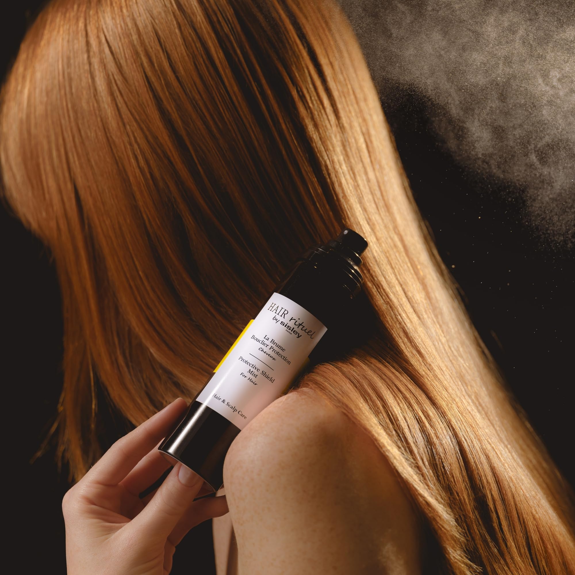 Weightless spray texture of Sisley Hair Rituel Shield Mist on hair.