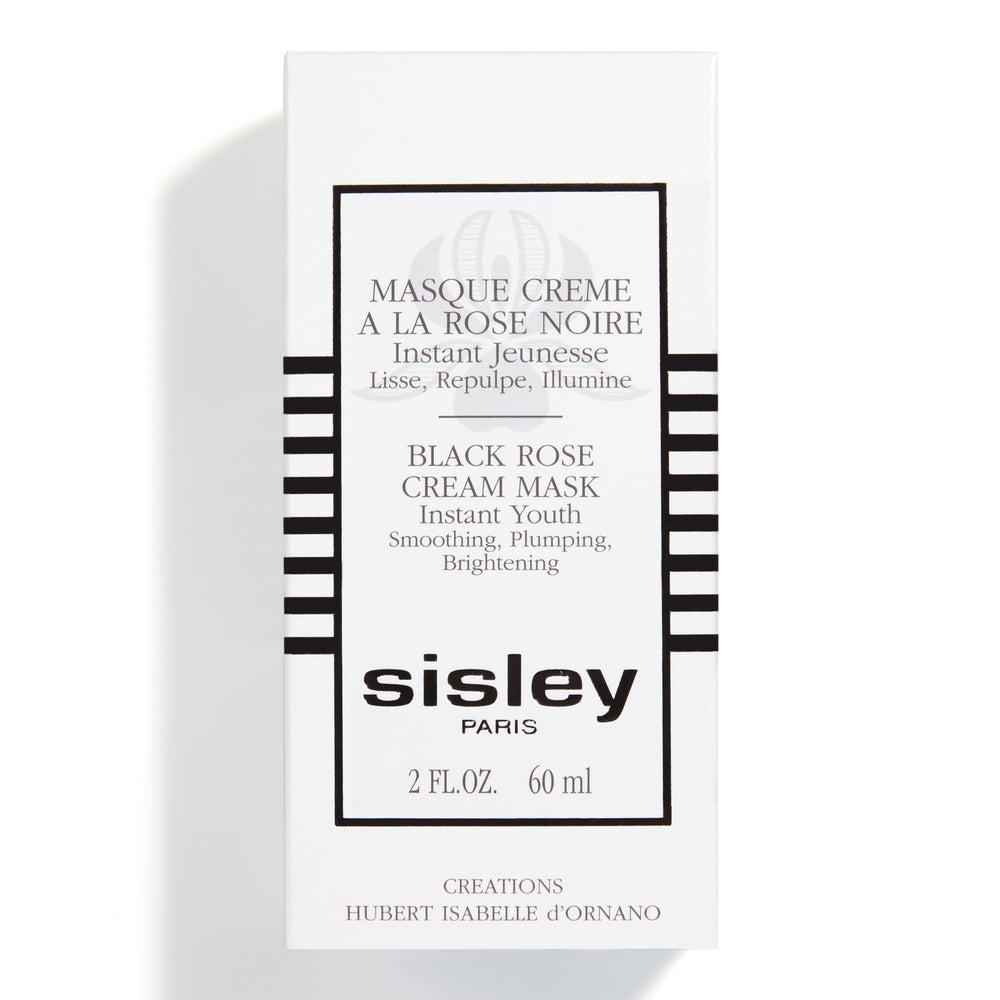 Applying Sisley Paris Black Rose Cream Mask to face and neck for a refreshed look.