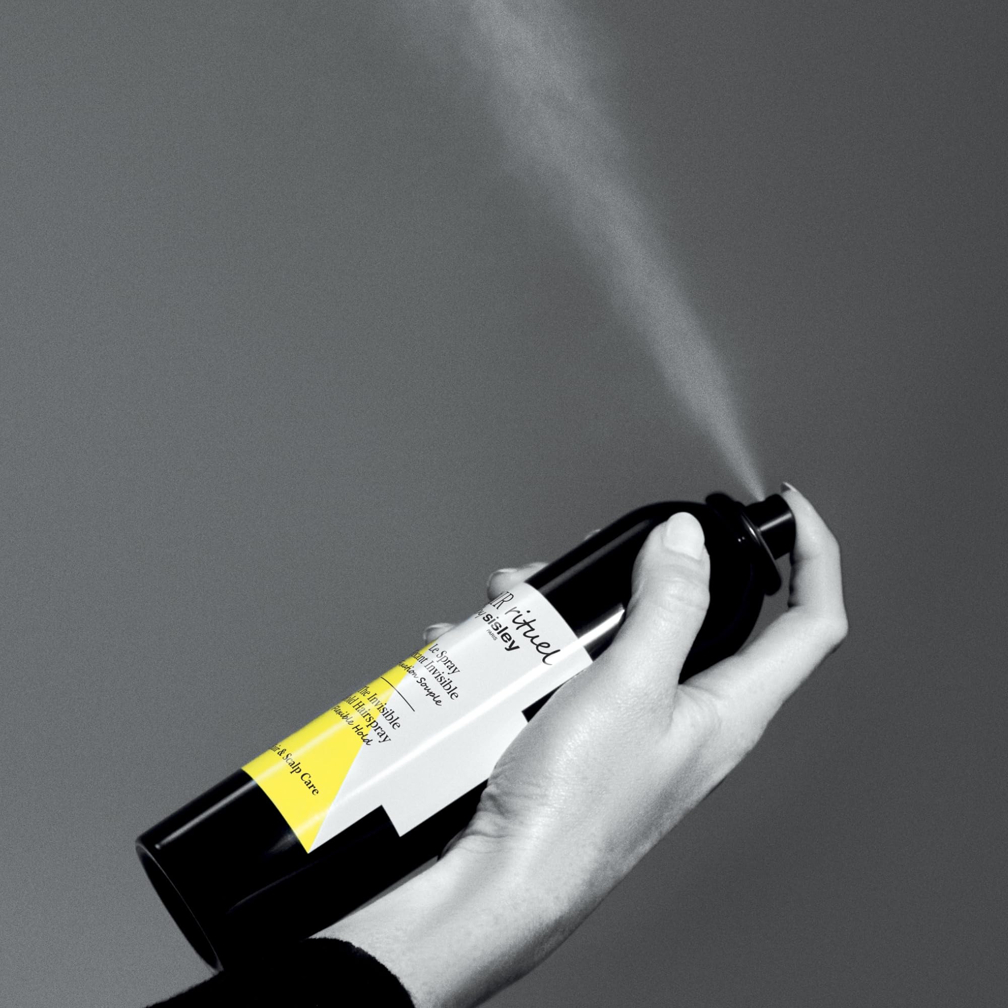 Sisley Paris Invisible Hold spray closeup label emphasizes nature-meets-science formula for shine.