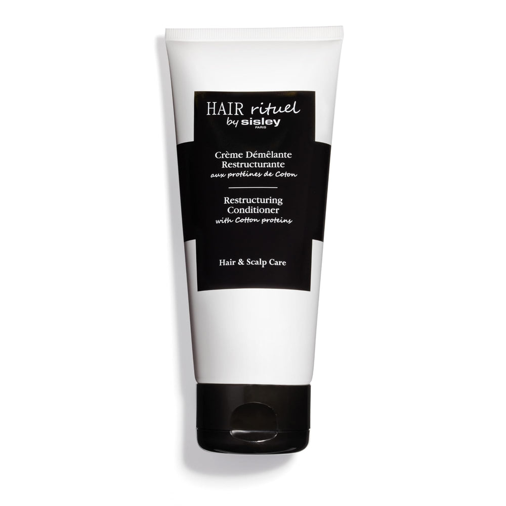Sisley Paris Restructuring Conditioner bottle highlighting cotton proteins for smoother detangling.