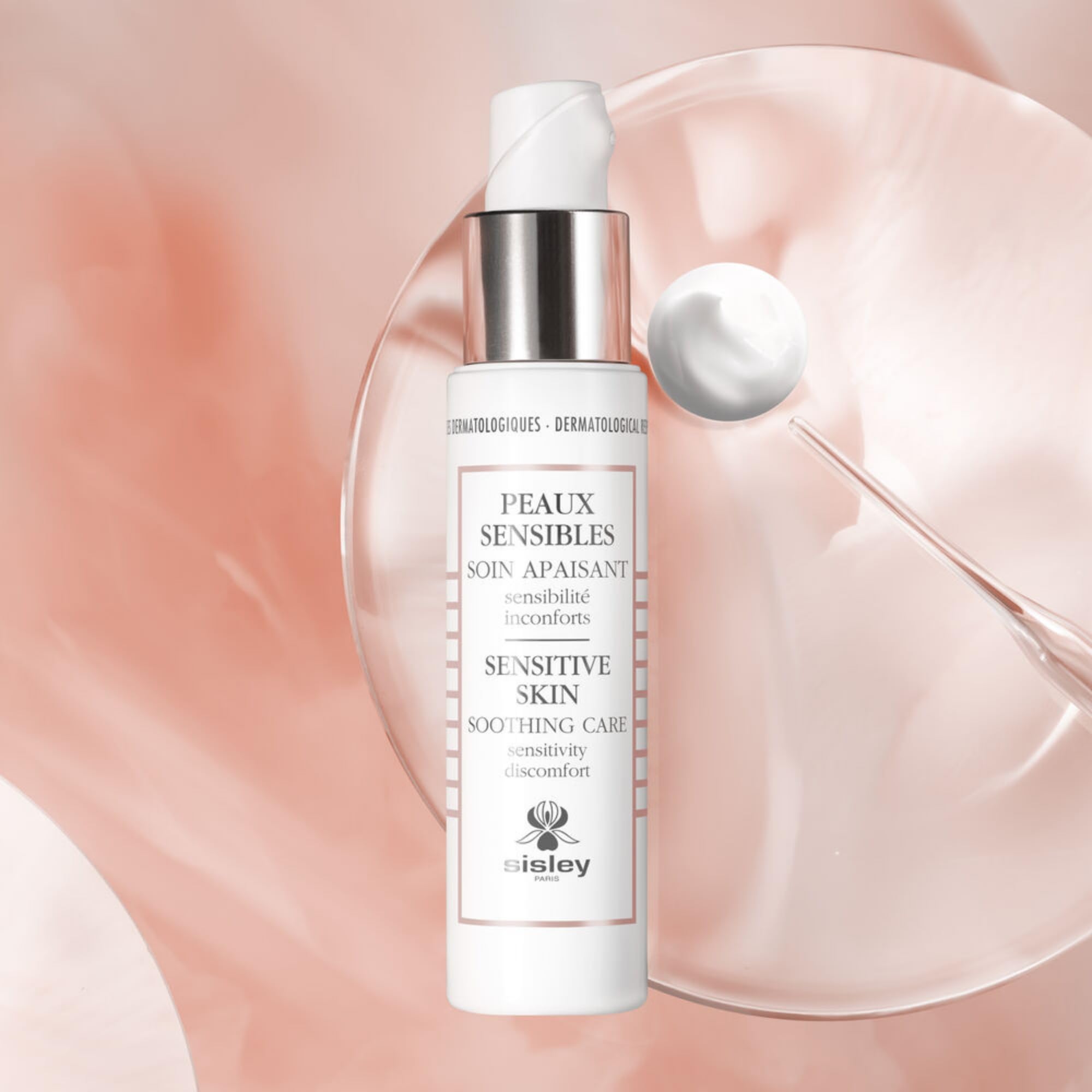 Gently massaging Sisley Paris Sensitive Skin Soothing Care into the face.