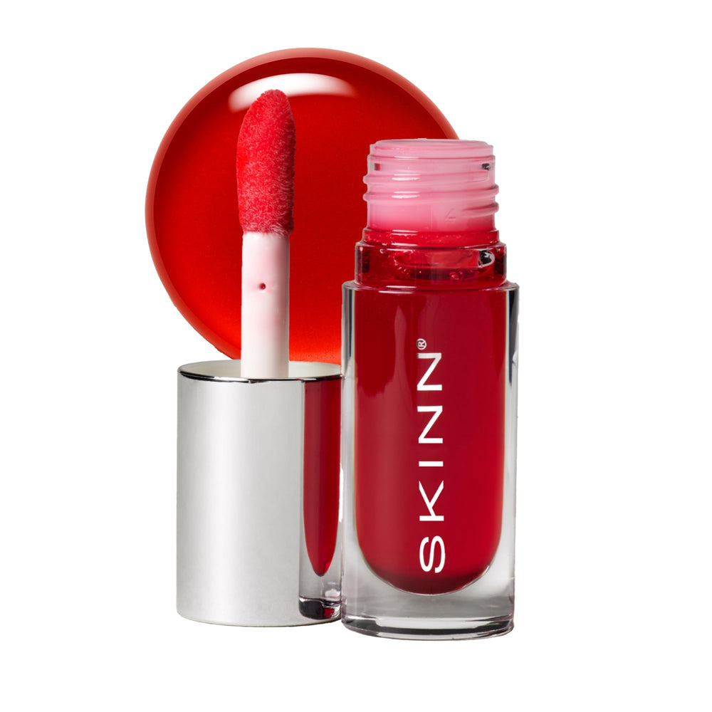 SKINN Luminous Crimson Lip Oil on lips delivers lasting hydration and glassy shine
