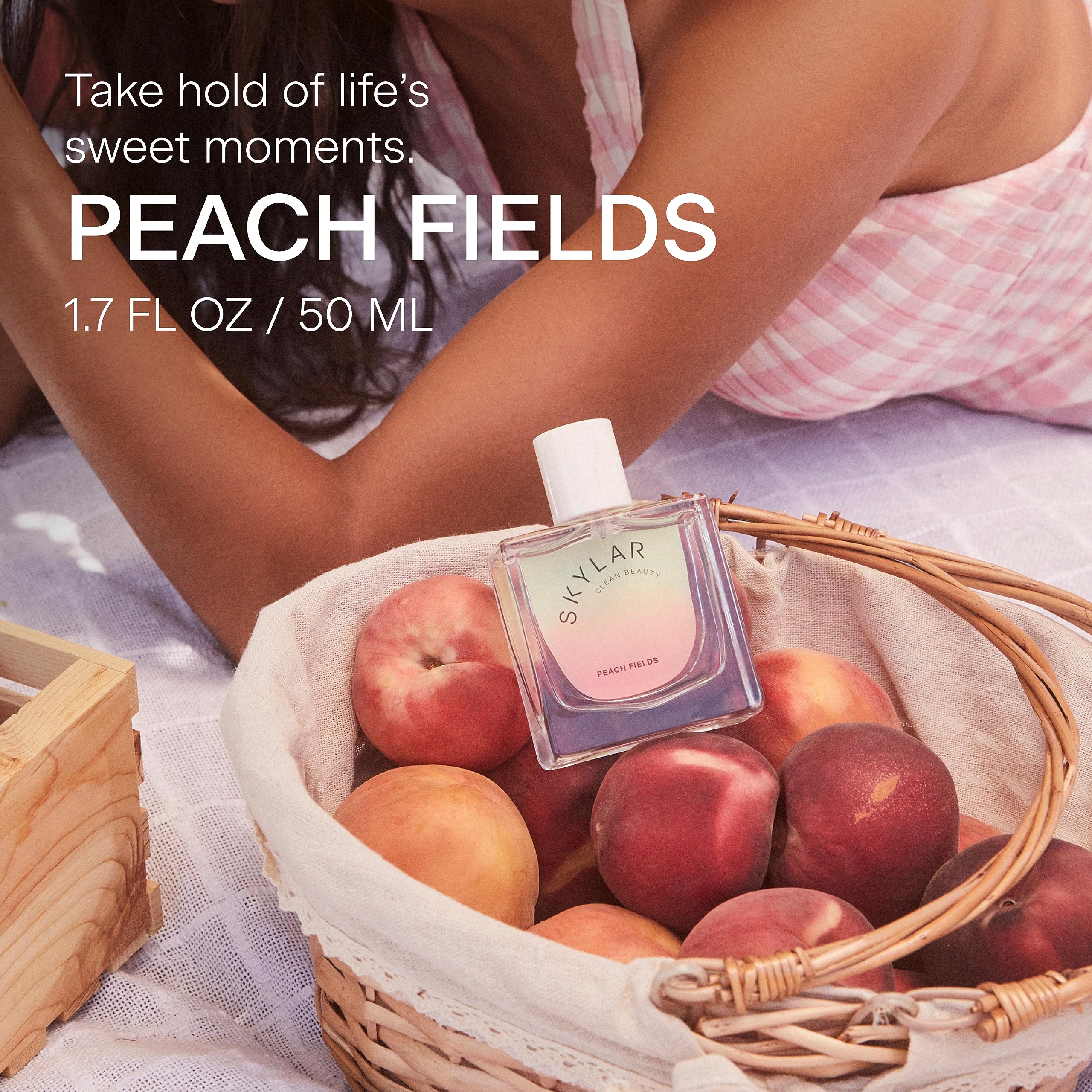 Perfume swatch on skin reveals peach and citrus balance.