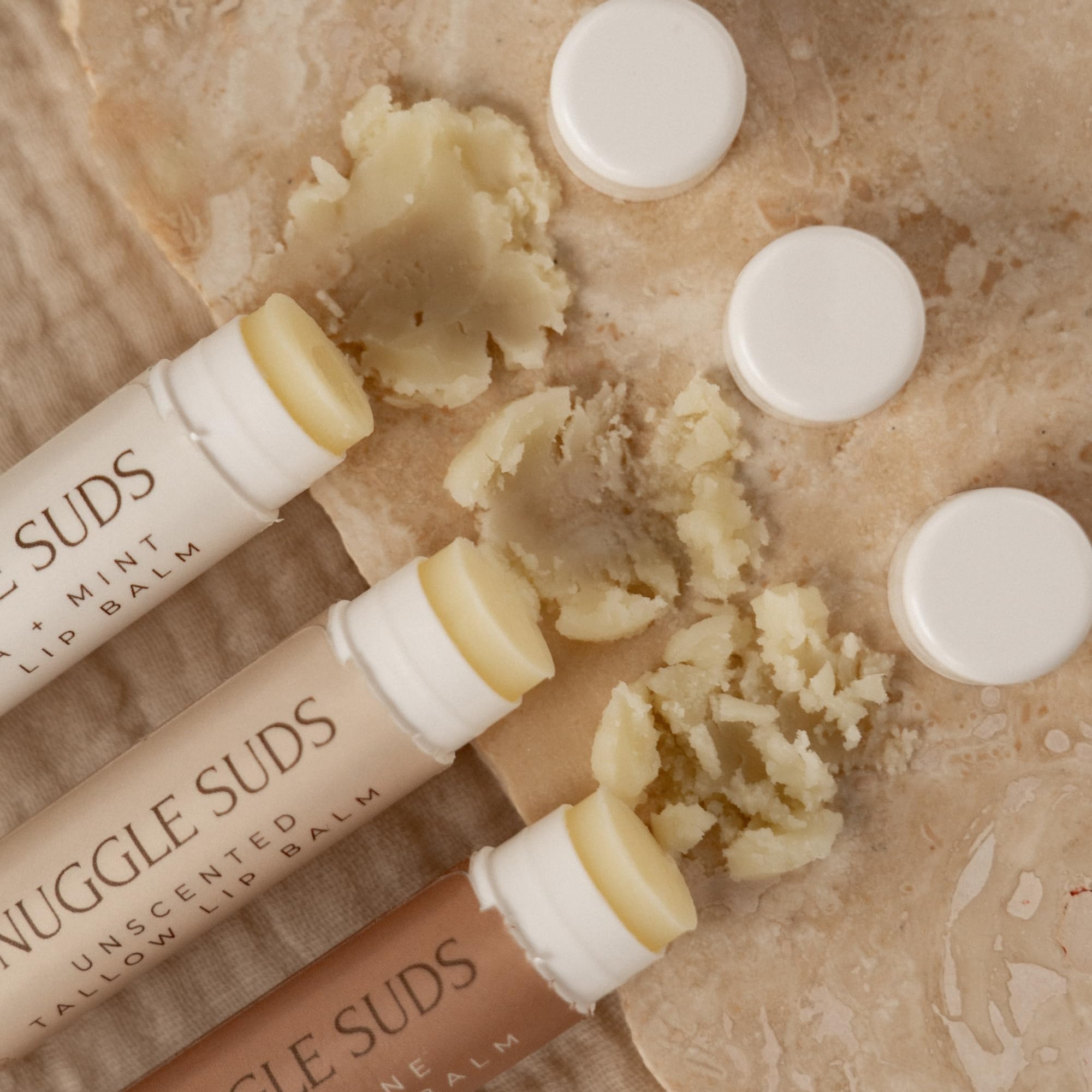 Melt-on-contact Snuggle Suds lip balm relieving dry lips with smooth application.