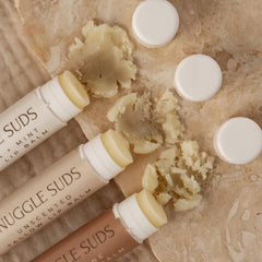 Melt-on-contact Snuggle Suds lip balm relieving dry lips with smooth application.